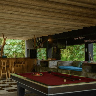 A pool table in the games area of a hostel