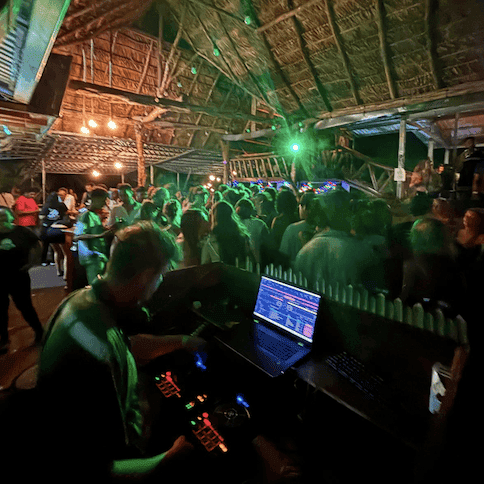 Photo of a crowded room of dancers in the dark