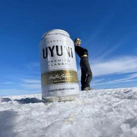 Cat leaning against a beer can perspective photo on the Uyuni Salt Flat