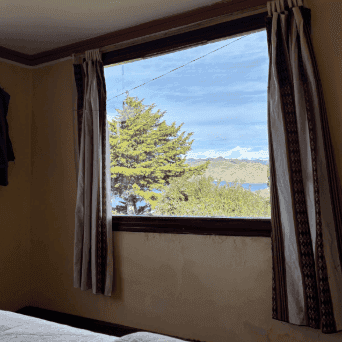 Photo of a room with a beautiful view of a lake and trees
