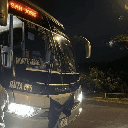 A white bus with a makeshift material bow-tie