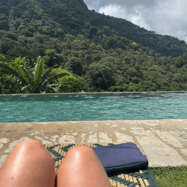 A pool overlooking beautiful green mountains