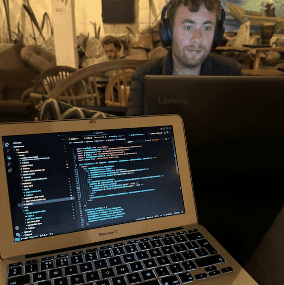 Laptop pictured with others working in the background