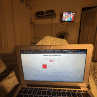 Laptop pictured on a bed in a private room